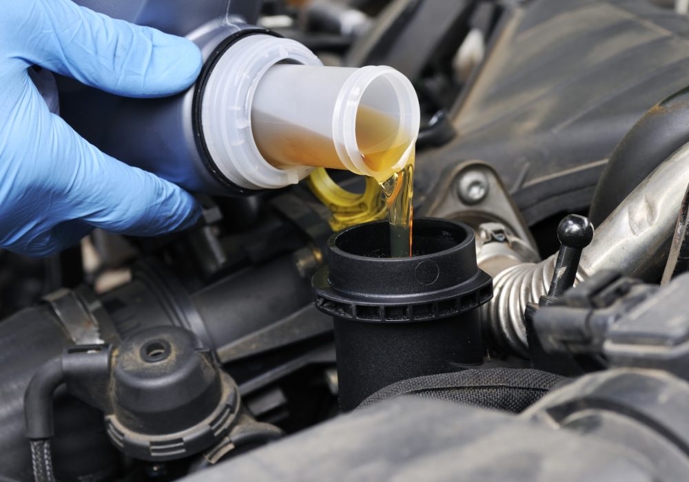 Mechanic doing an oil change on a car